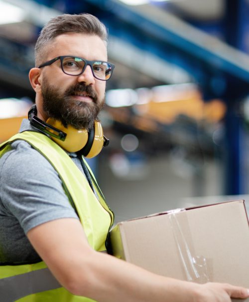 Man worker working in industrial factory or warehouse